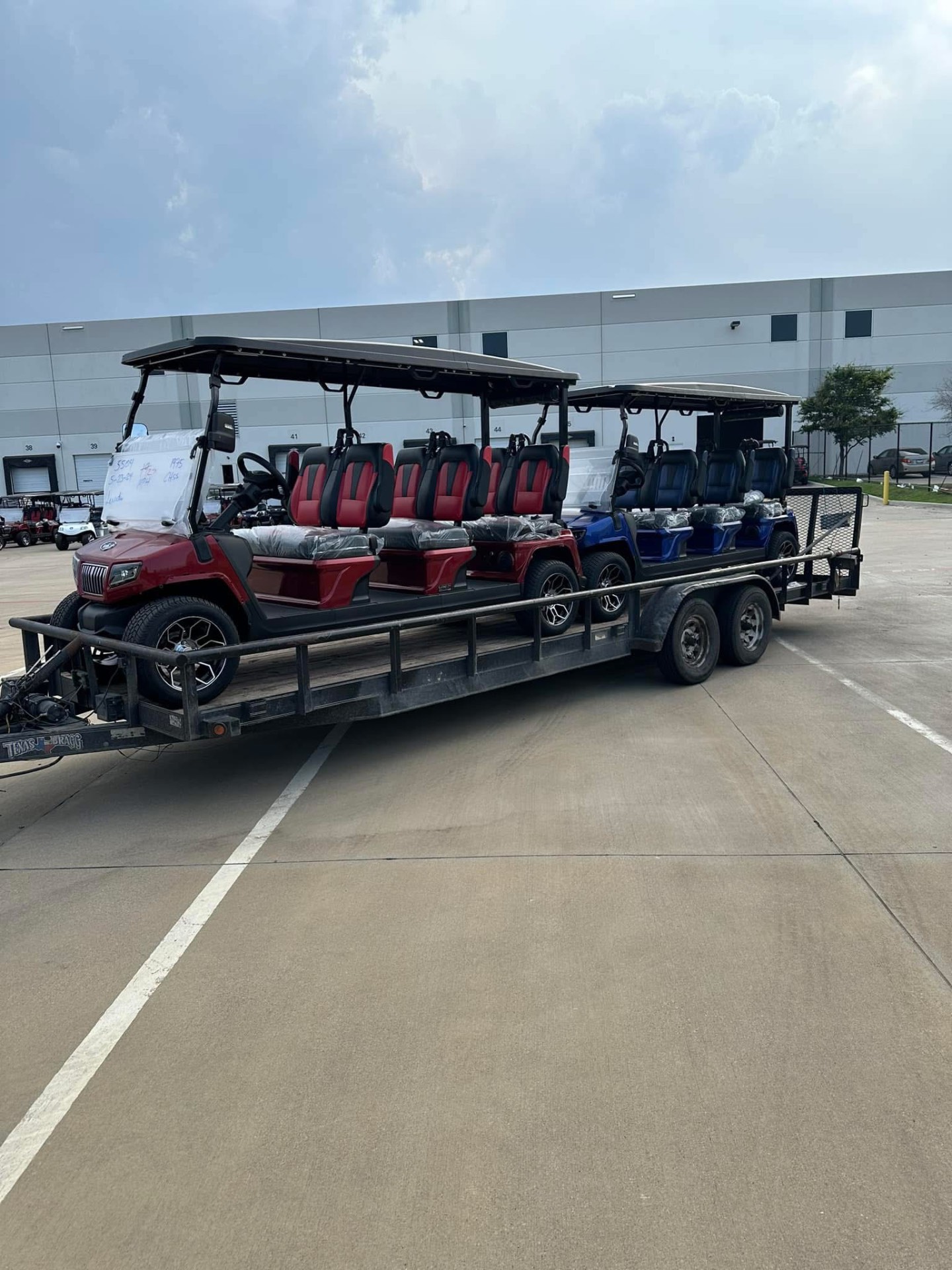 Trailer hauling a row of new golf carts for a San Antonio delivery